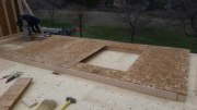 Second floor walls are sheathed before being erected