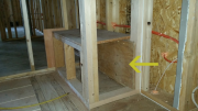 Insulation barrier behind shower seat.