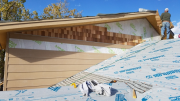 Shingle siding installation in progress