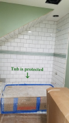 Installing tile in daughters bath. Tub is protected
