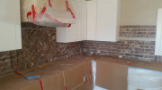 Reclaimed brick backsplash in kitchen