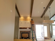 Carlos installing shiplap at fireplace