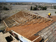 Trusses are placed on top of old roof