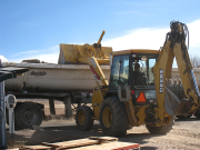 Broken concrete and dirt are hauled away