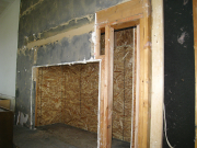 Sheathing behind fireplace to hold insulation