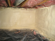 Crawlspace foundation walls are sprayed with foam