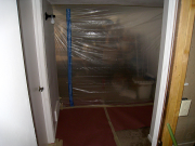 Basement is divided with plastic and zipper door