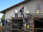 Stucco crew applies finish coat