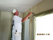 Tracy is painting wall
