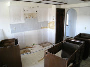 Kitchen cabinets and appliances are removed