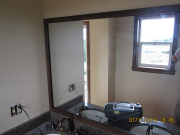 Wood framed mirror installed