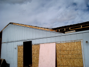 Part of old roof above new garage is removed