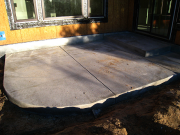 Rear concrete patio is placed with moisture and flashing control at wall