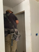 Carlos installing drywall