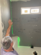 Checking walls for plumb prior to tile installation