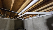Plumbing drain pipes in crawlspace below studio bathroom 