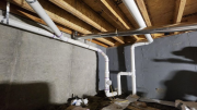 Plumbing, radon and duct below pantry