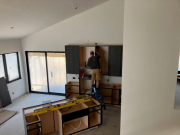 Kitchen cabinets being installed