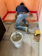 Marcelo applying tile mastic on Schluter shower pan