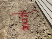 Sleeve location under sidewalk is marked