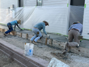 Three men of a 12-man team finishing the east sidewalk