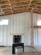 Blown-in blanket insulation over closed cell foam insulation